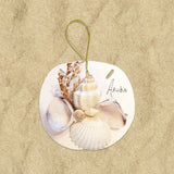 A round, beige holiday ornament featuring a shell cluster with greenery and the name 'Horide' printed on it.